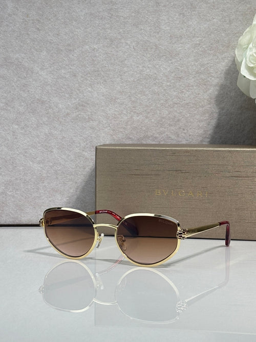 Gold-tone round sunglasses with dark gradient lenses and slim metal arms