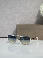 Silver-tone oval sunglasses with gradient blue lenses and metal bridge details