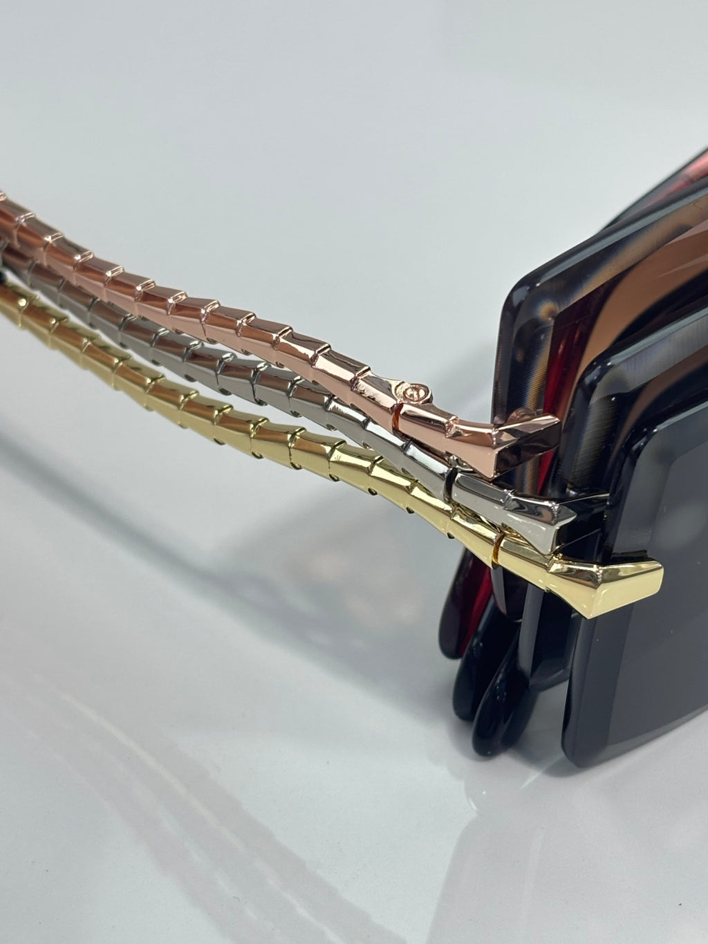 Bvlgari sunglasses temple chain detail with gold links and hinge