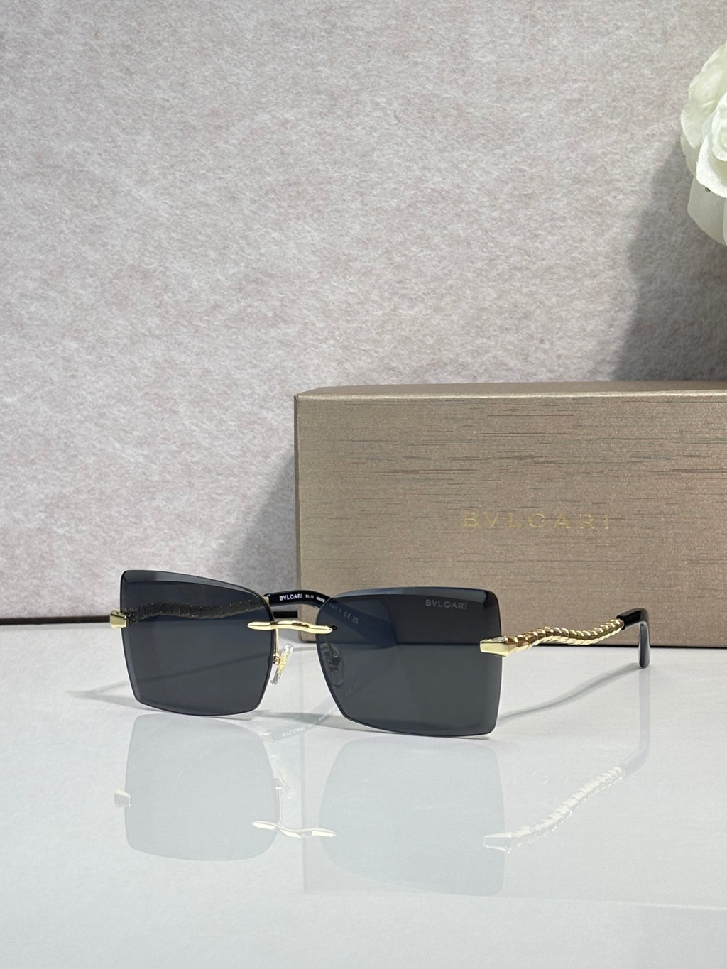 Bvlgari rectangular sunglasses with gold frame and dark gray lenses