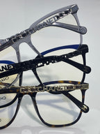 Eyeglasses close-up of dark blue chain strap with gold CHANEL letters and temple caps.