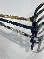 Chanel glasses temple detail with gold chain links and navy braided accent