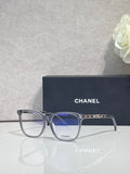 Chanel glasses with dark frames and blue-tinted lenses, logo on the temples