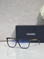 Chanel eyeglasses with dark frames and blue-tinted lenses, side profile view