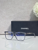 Dark blue rectangular eyeglasses with blue-tinted lenses and gold Chanel logo on bridge