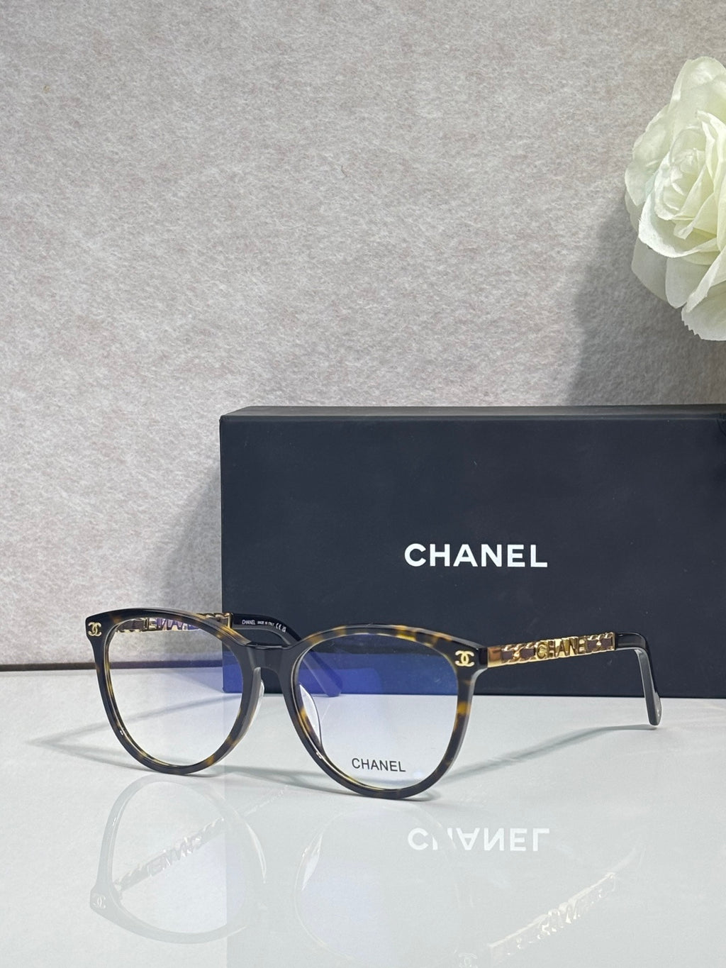 Chanel eyeglass frames, dark blue with gold CHANEL branding on temples and front