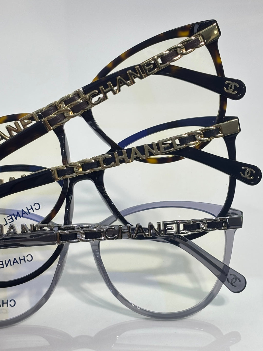 Chanel eyeglass frames angled view, gold chain temple detail and logo accents