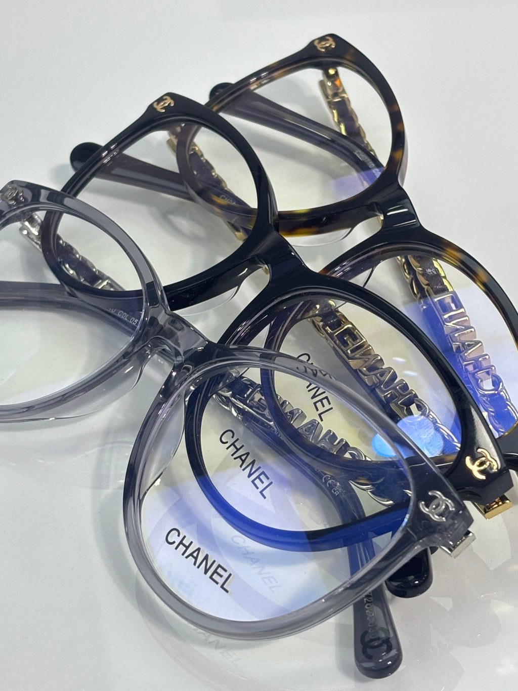 Chanel eyeglass frames, dark blue and clear acetate with gold CHANEL logos on lenses