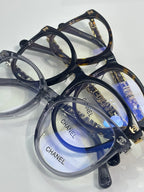Chanel eyeglass frames, dark blue and clear acetate with gold CHANEL logos on lenses