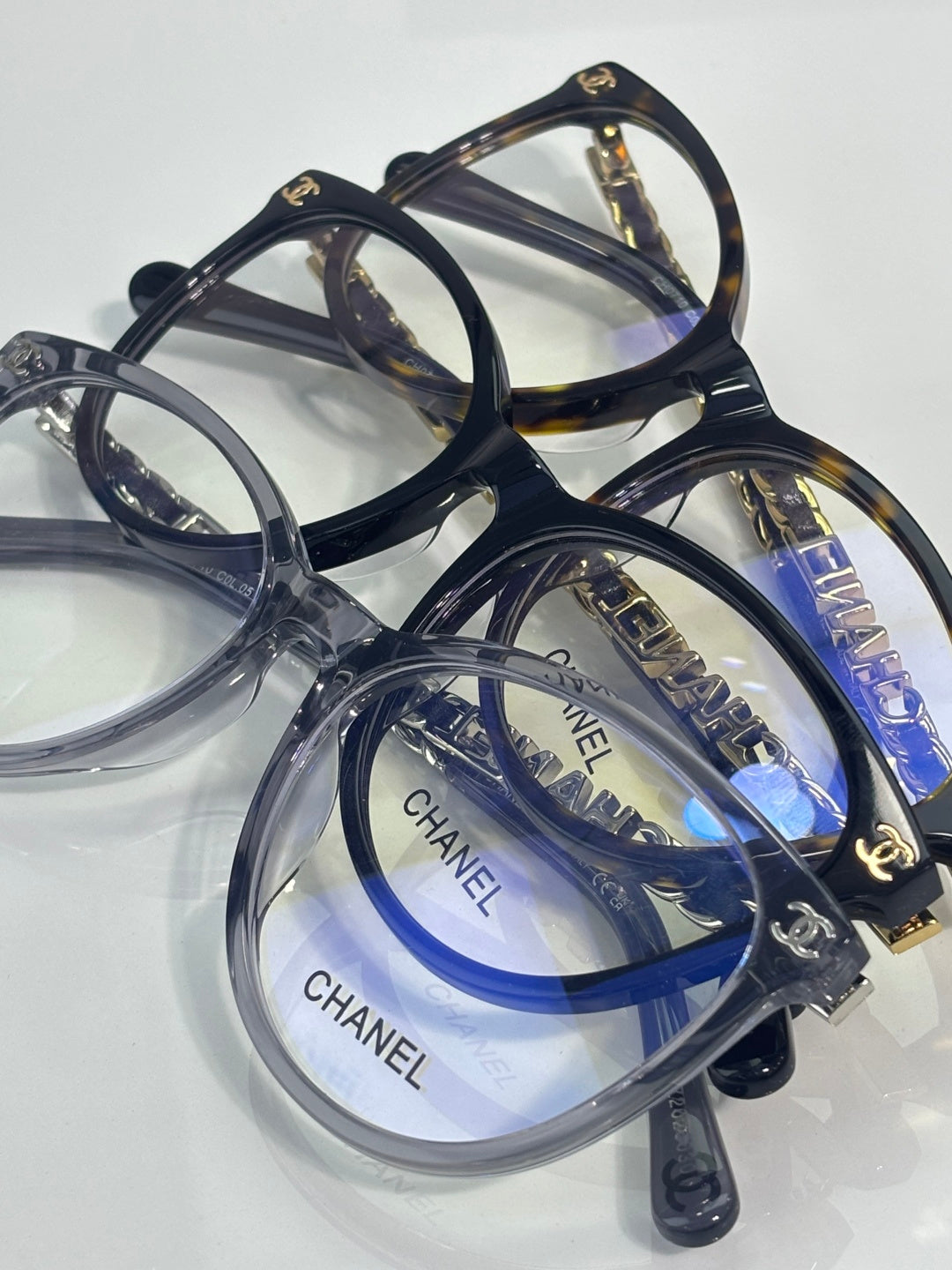 Chanel eyeglass frames, dark blue and clear acetate with gold CHANEL logos on lenses