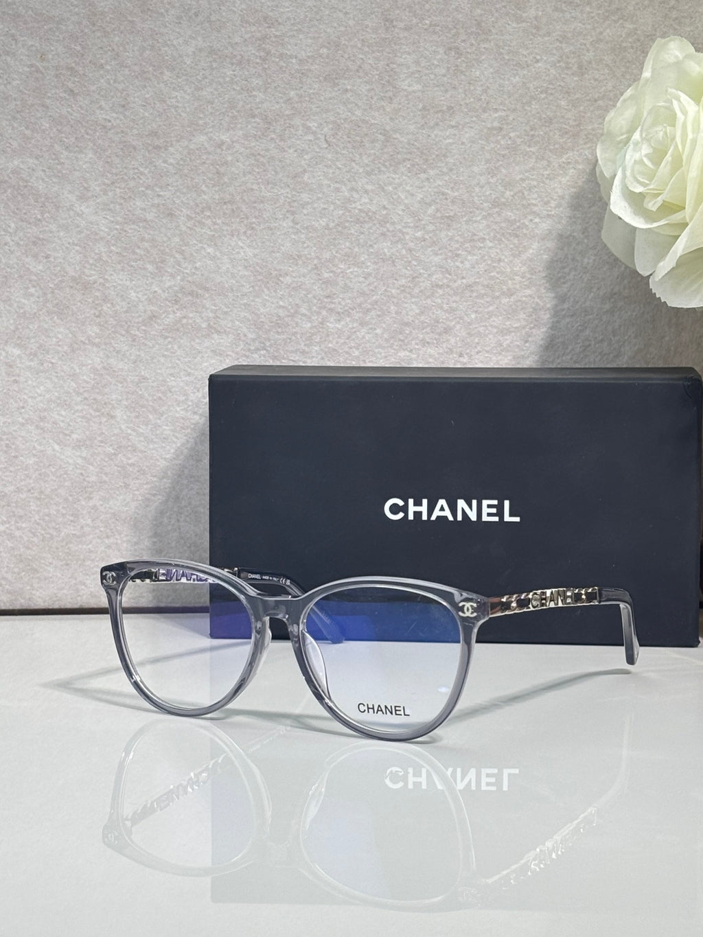 Chanel eyeglass frames, round dark blue acetate with gold CHANEL detail at hinges
