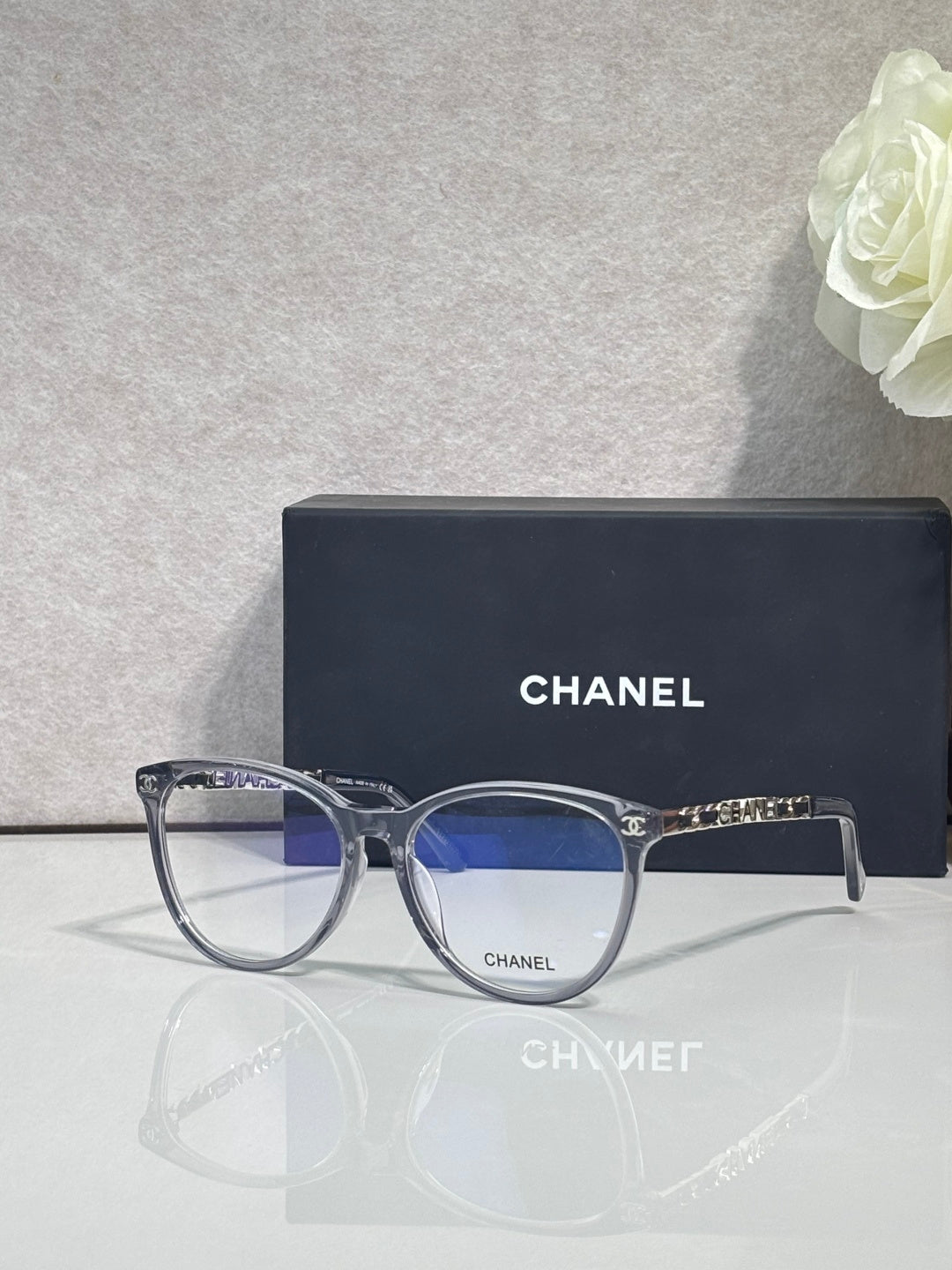 Chanel eyeglass frames, round dark blue acetate with gold CHANEL detail at hinges