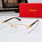 Cartier eyeglasses with gold frame, clear lenses, and tortoiseshell temple section.