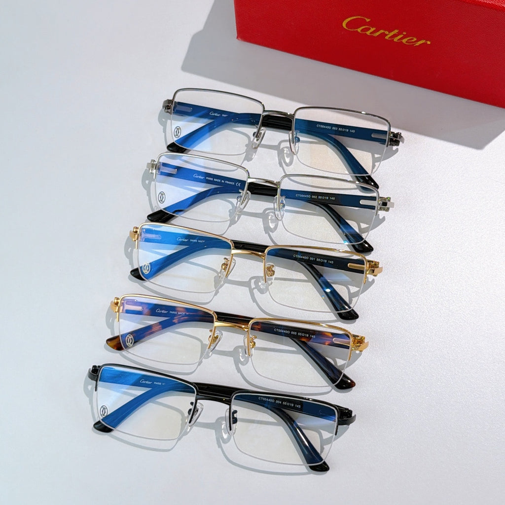 Stack of Cartier eyeglasses with blue temple accents and mixed frame colors.
