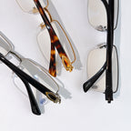 Close-up of Cartier eyeglasses with tortoiseshell and black temple accents.