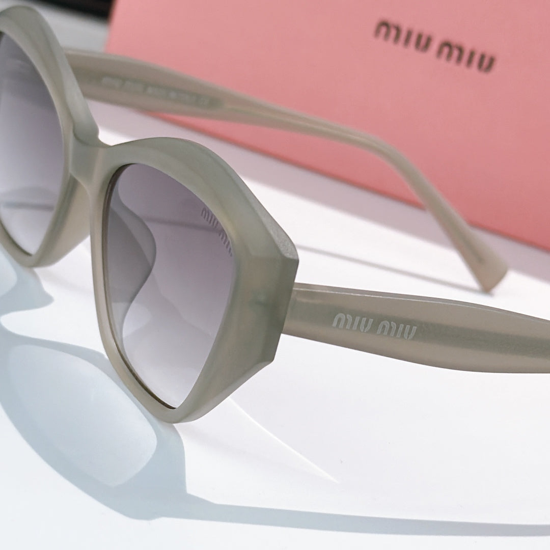Light gray cat-eye sunglasses close-up, showing temple and lens shape