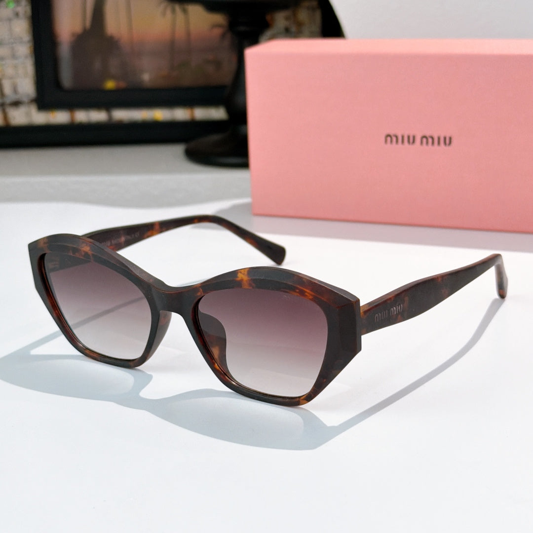 Tortoise cat-eye sunglasses with dark gradient lenses and glossy frame