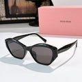 Black cat-eye sunglasses with dark tinted lenses and glossy frame