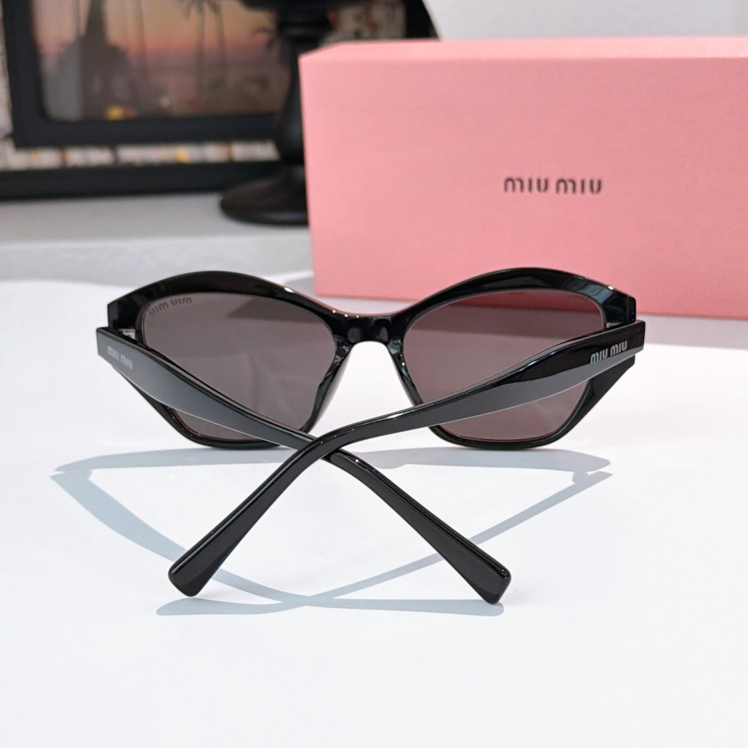 Black cat-eye sunglasses with dark tinted lenses and sculpted center bridge