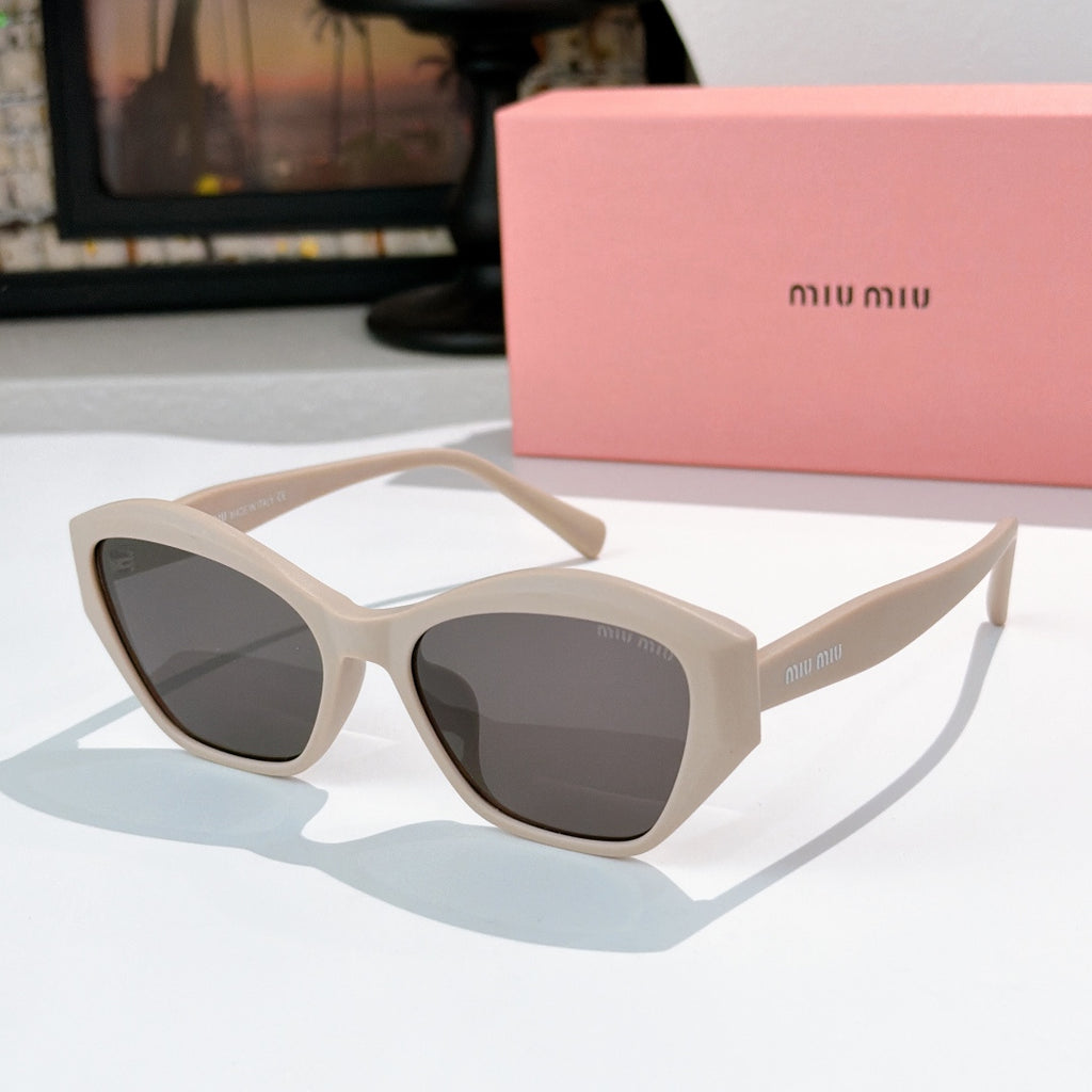Cream cat-eye sunglasses with dark tinted lenses and curved glossy frame
