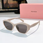 Cream cat-eye sunglasses with dark tinted lenses and curved glossy frame