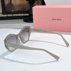 Light gray cat-eye sunglasses side view with tinted lenses and logo on arm