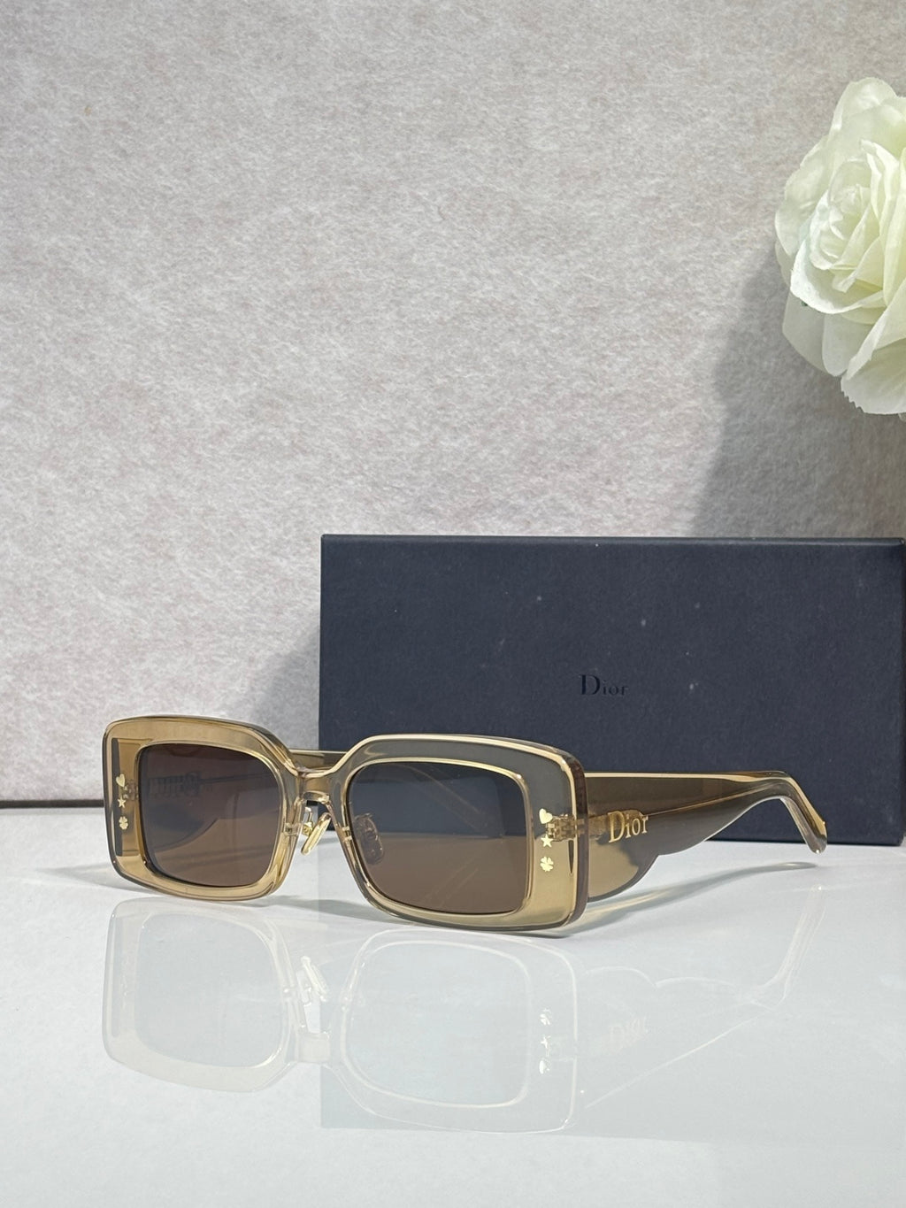 Dior sunglasses with gold-tone frame and dark brown square lenses