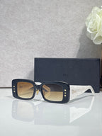 Dior sunglasses with dark frame and amber-tinted square lenses