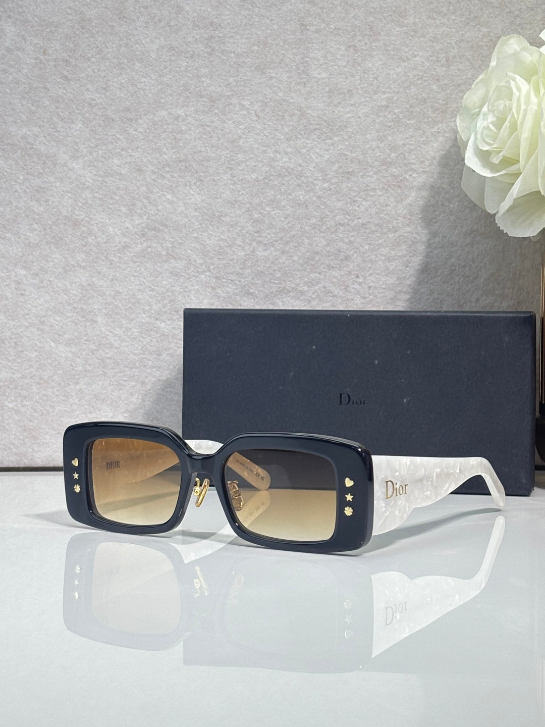 Dior sunglasses with dark frame and amber-tinted square lenses