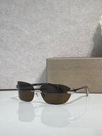 Sunglasses with dark lenses and silver-and-gold metal frame, front angle view.