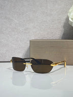 Sunglasses with dark lenses and gold metal frame, three-quarter view.
