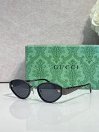 Cat-eye sunglasses with black frames and dark tinted lenses