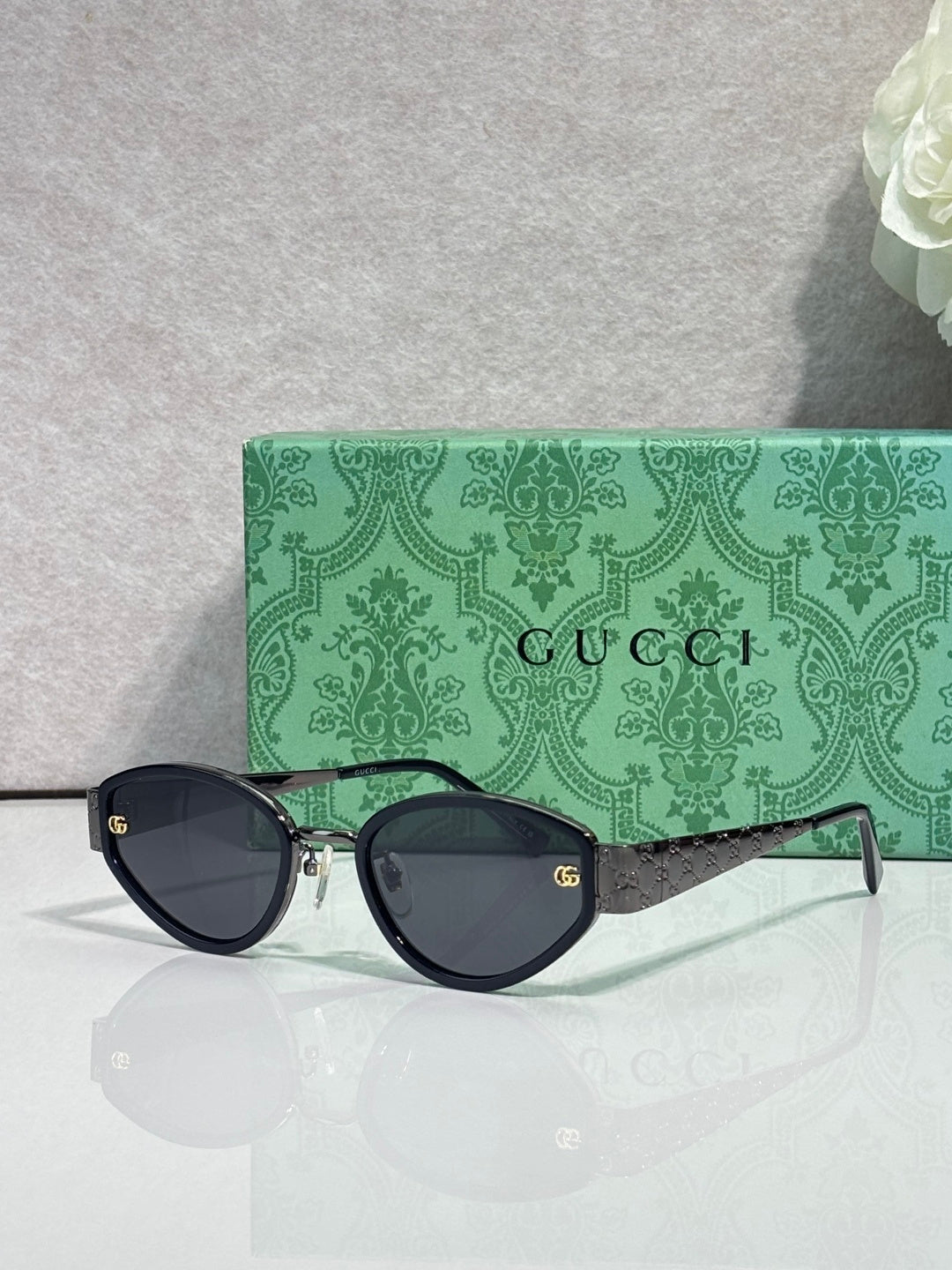Cat-eye sunglasses with black frames and dark tinted lenses
