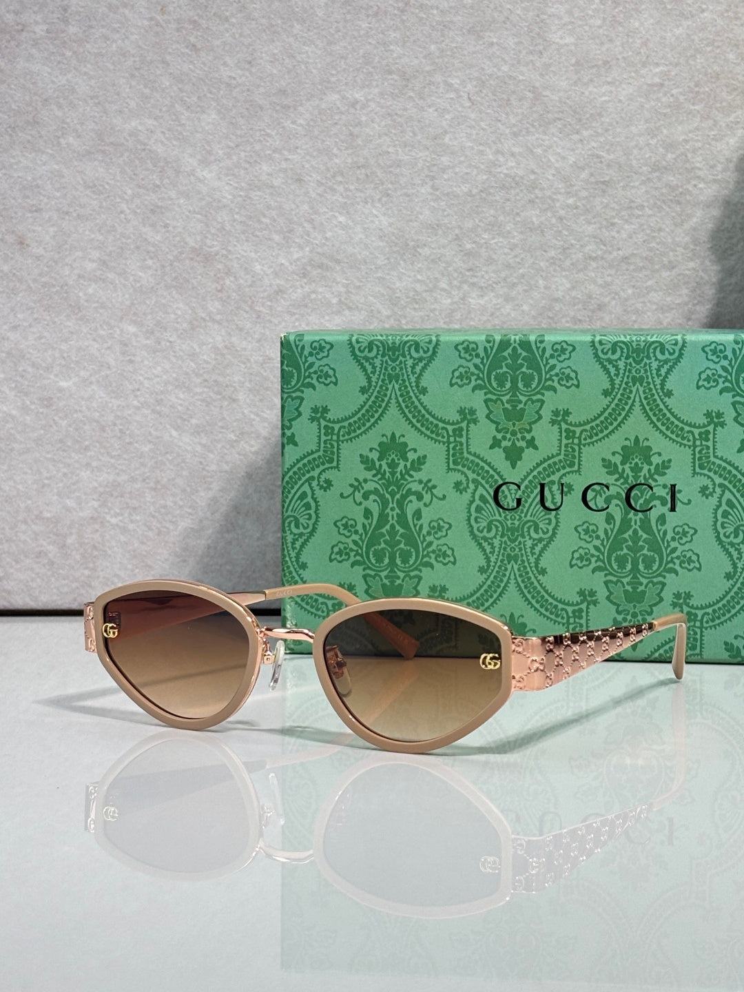 Cat-eye sunglasses with rose-gold frames and warm gradient lenses