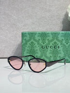 Cat-eye sunglasses with black frames and pink-tinted gradient lenses