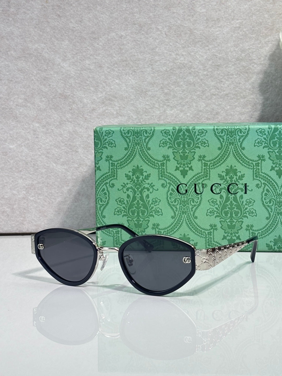 Cat-eye sunglasses with black frames and dark-tinted lenses