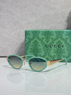 Cat-eye sunglasses with teal frames and light gradient lenses