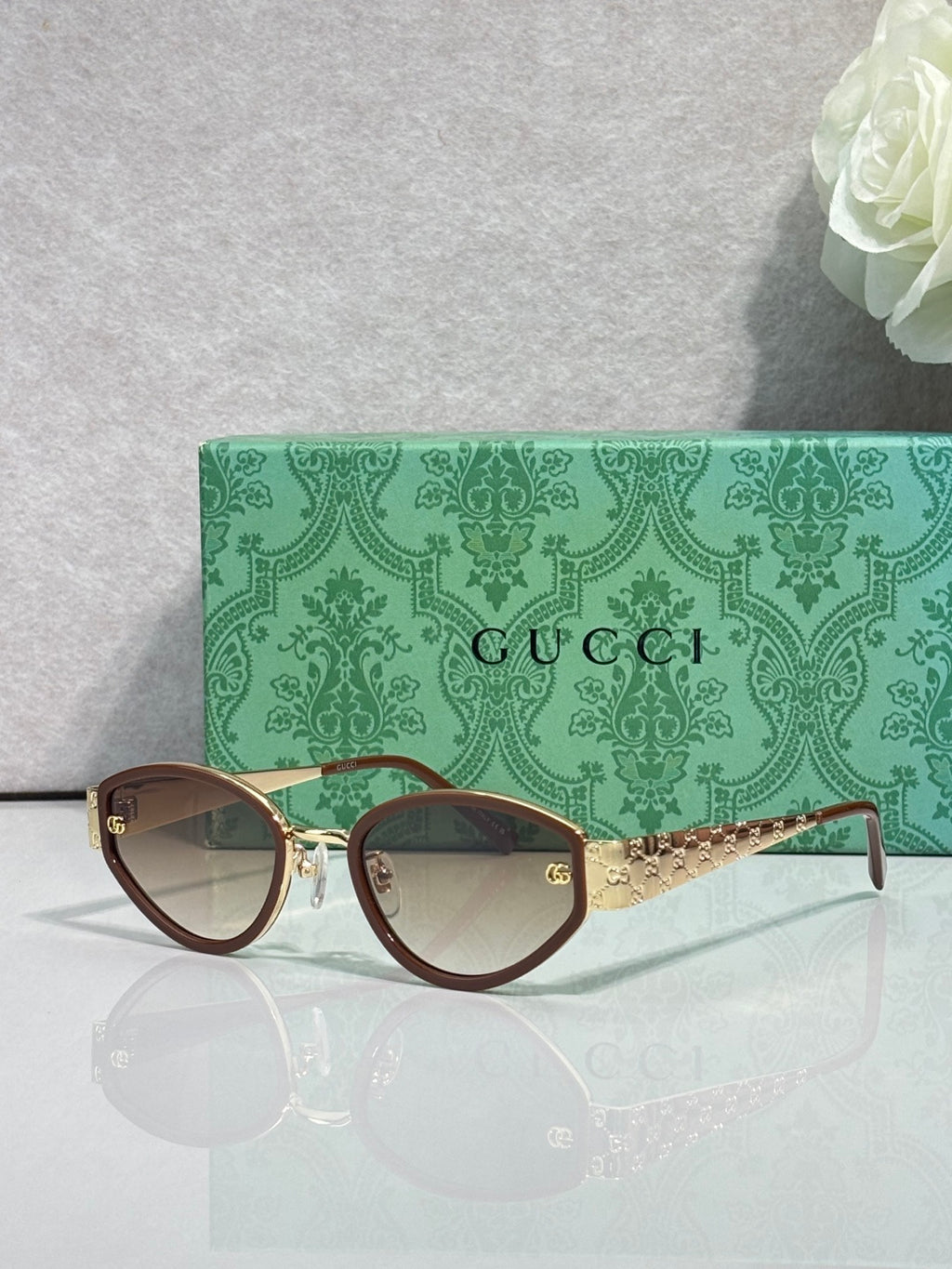 Gucci cat-eye sunglasses with dark-brown frames and clear gradient lenses