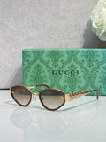 Gucci cat-eye sunglasses with dark-brown frames and clear gradient lenses