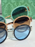 Gucci stacked round sunglasses with teal and tan lenses and gold logo arms