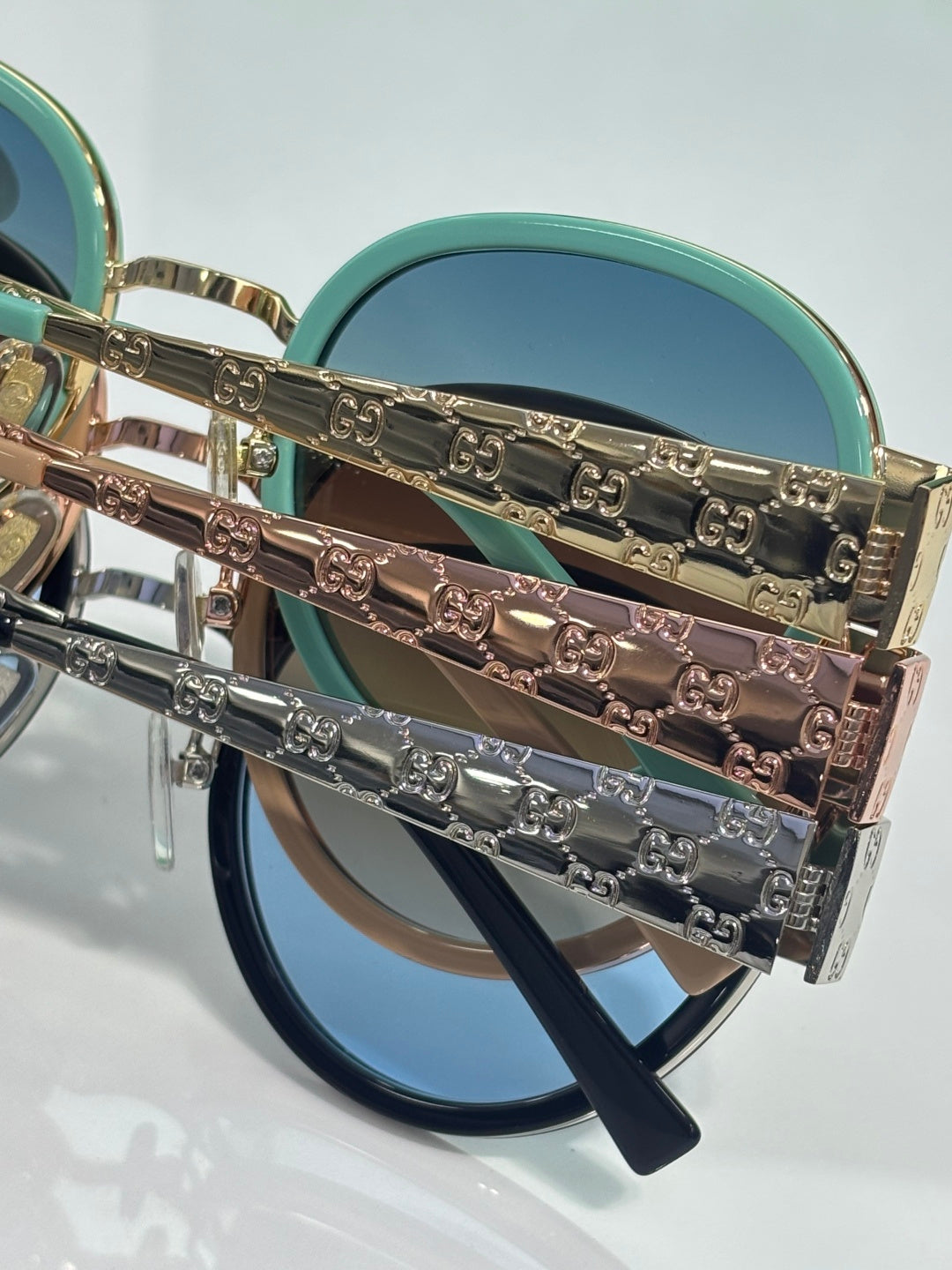 Gucci round sunglasses with teal and blue lenses and engraved logo chain arms
