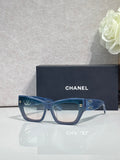 Eyeglasses with blue square frames and clear lenses, CHANEL logo on temples.