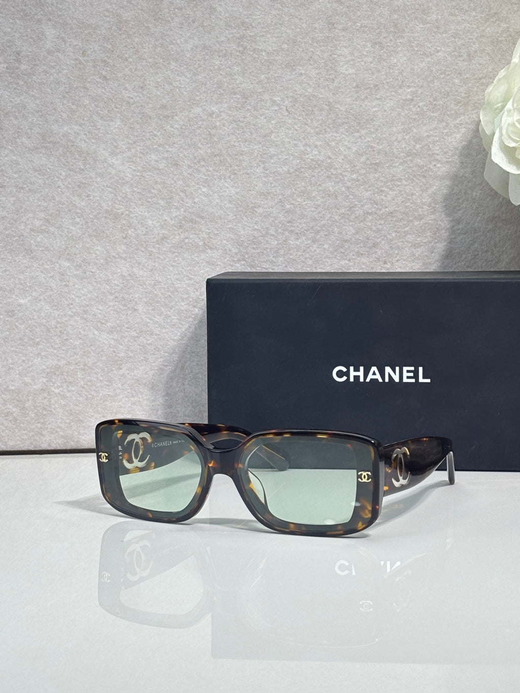 Tortoiseshell square-frame glasses with logo temples and tinted lenses