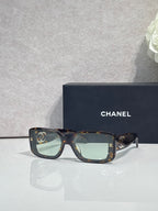 Tortoiseshell square-frame glasses with logo temples and tinted lenses