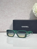 Green rectangular-frame glasses with logo hardware and tinted lenses