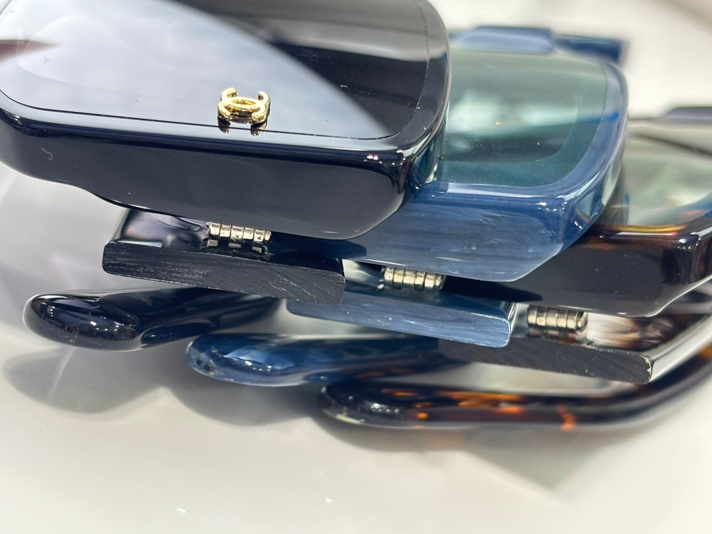 Glasses temples with gold-tone logo studs and tinted lens frames