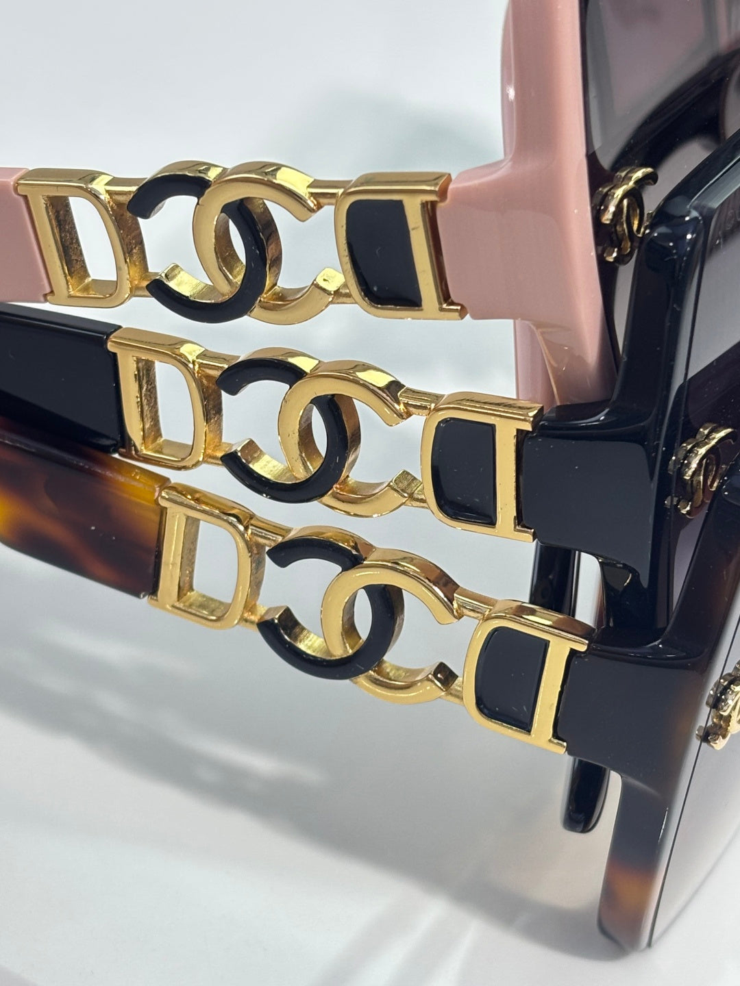 Chanel sunglasses, close-up of gold interlocking CC chain detail on frame