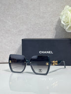 Chanel sunglasses with dark tortoise square frames, dark lenses, and gold hardware