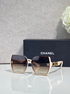 Chanel sunglasses with light pink square frames and dark lenses, gold temple detail