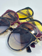 Gucci glasses in mixed colors with gold-trim frames and multitone tinted lenses